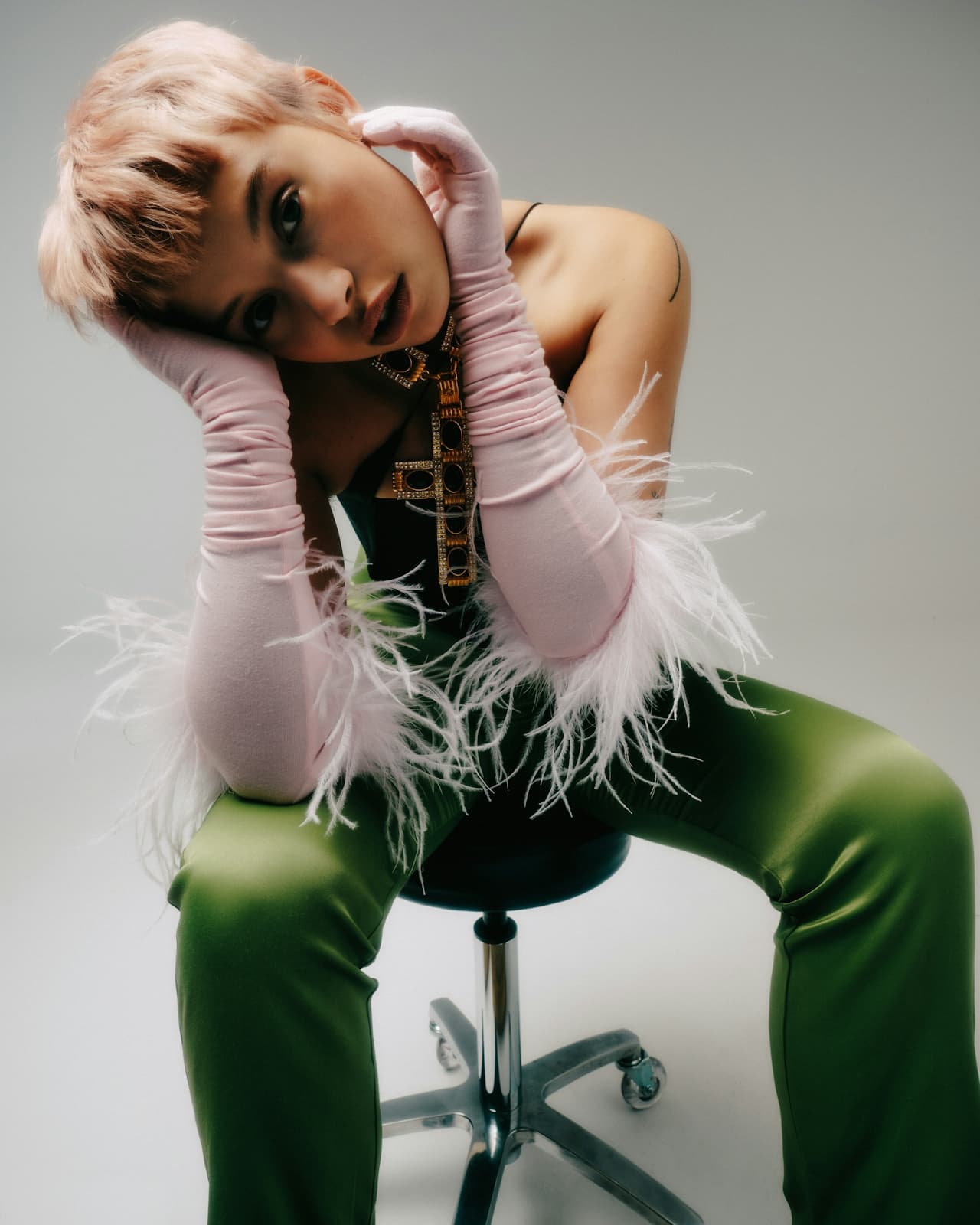 Editorial portrait — green satin and feather styling